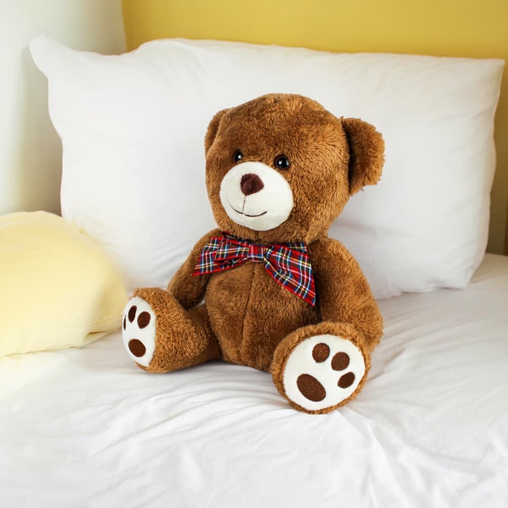 Milo Promo Bear on a bed