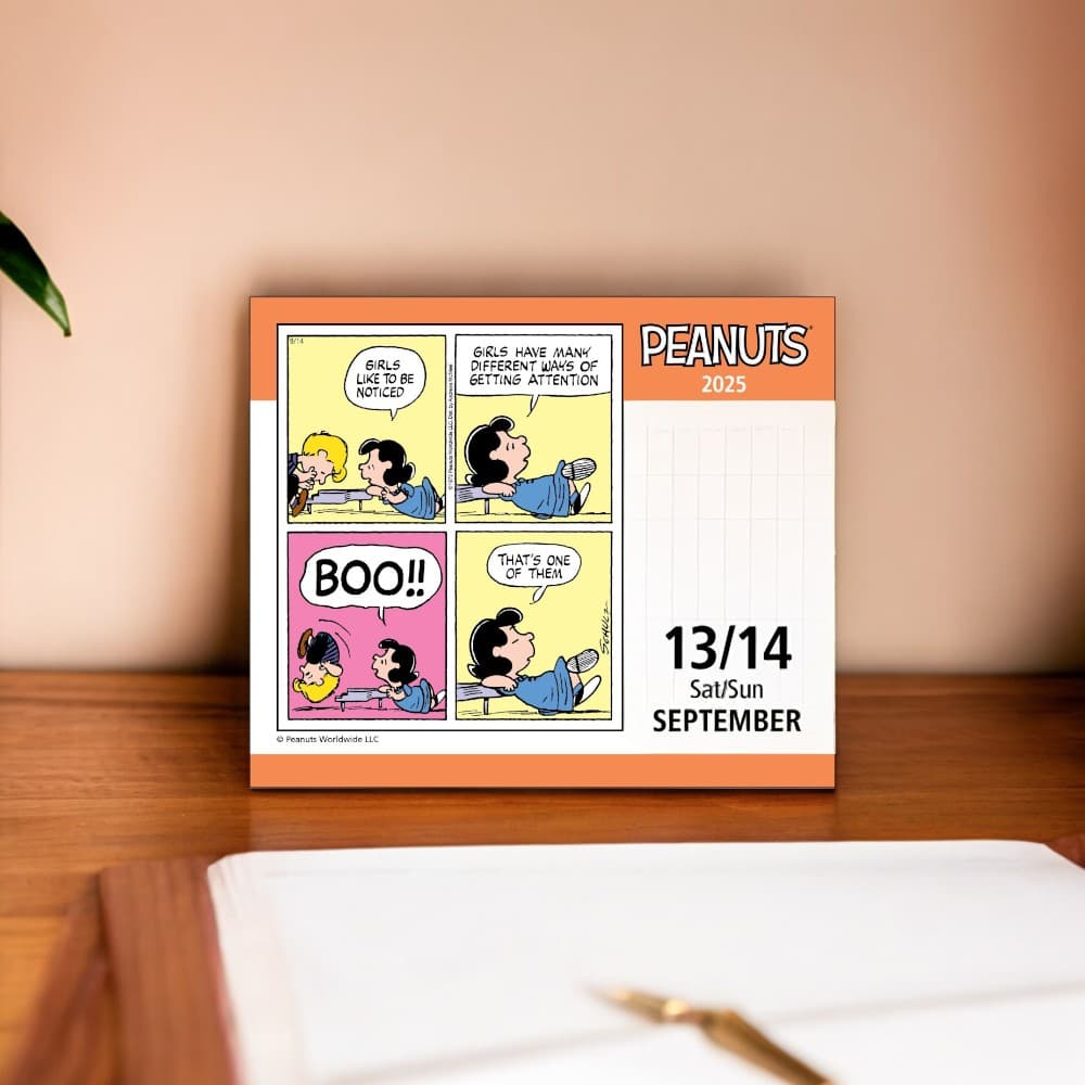 Peanuts 2025 Desk Calendar on a desk