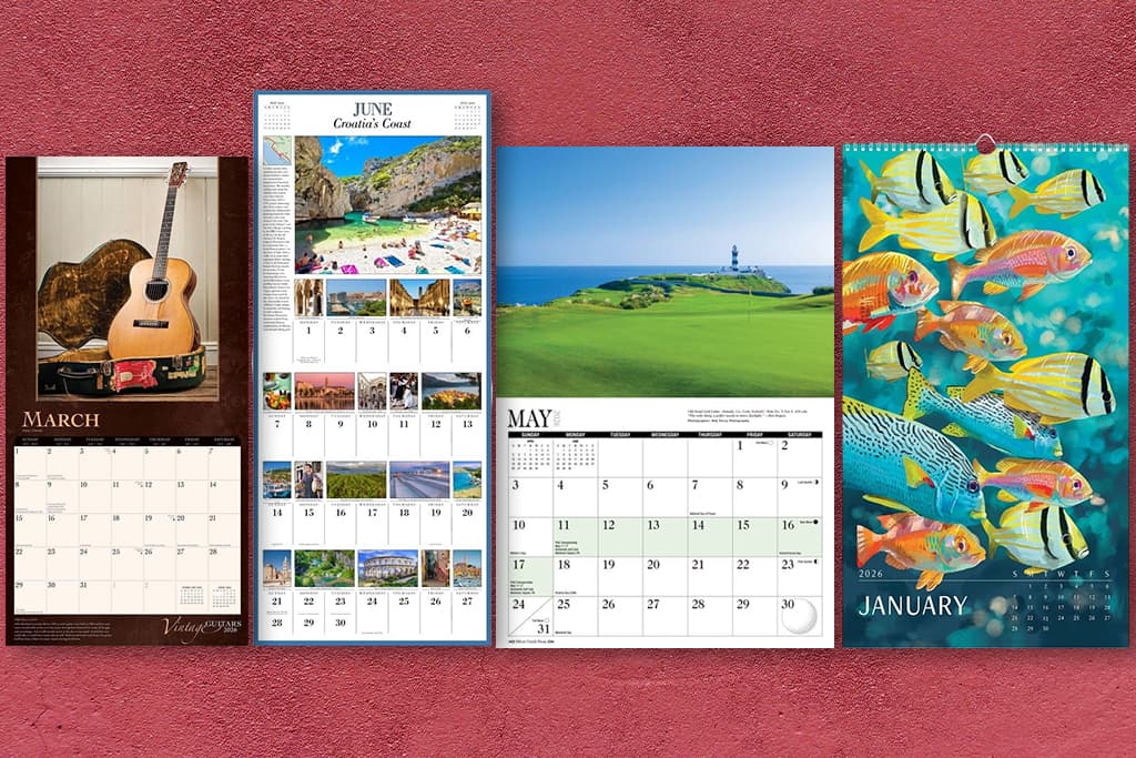Wall calendars in different sizes and formats displayed side by side on a red background